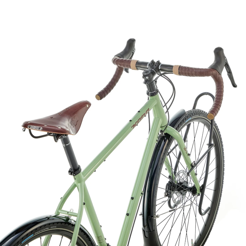 Green bicycle with brown handlebars and seat on a white background