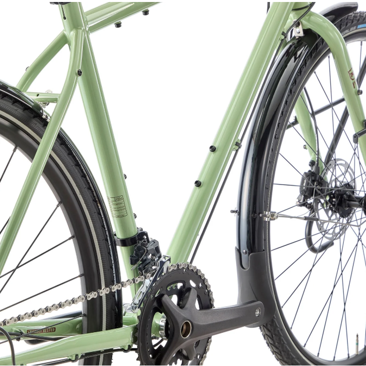 Close-up of a green bicycle with focus on the chain and gears.