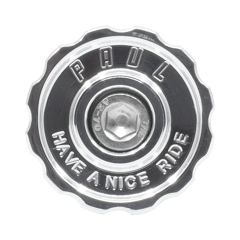 Metallic hubcap with 'PAUL' and 'HAVE A NICE RIDE' text on a white background