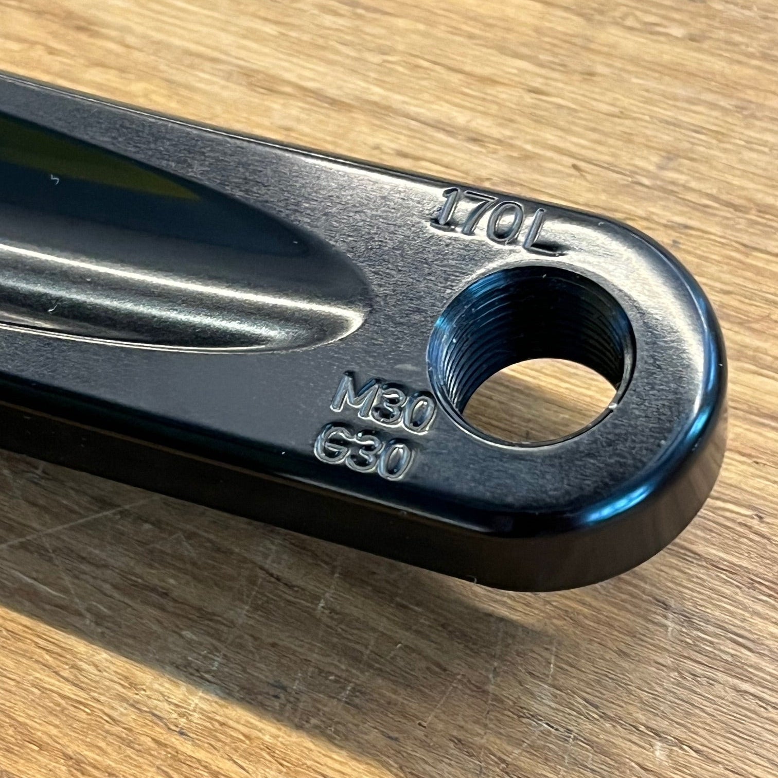 Metallic tool component on a wooden surface