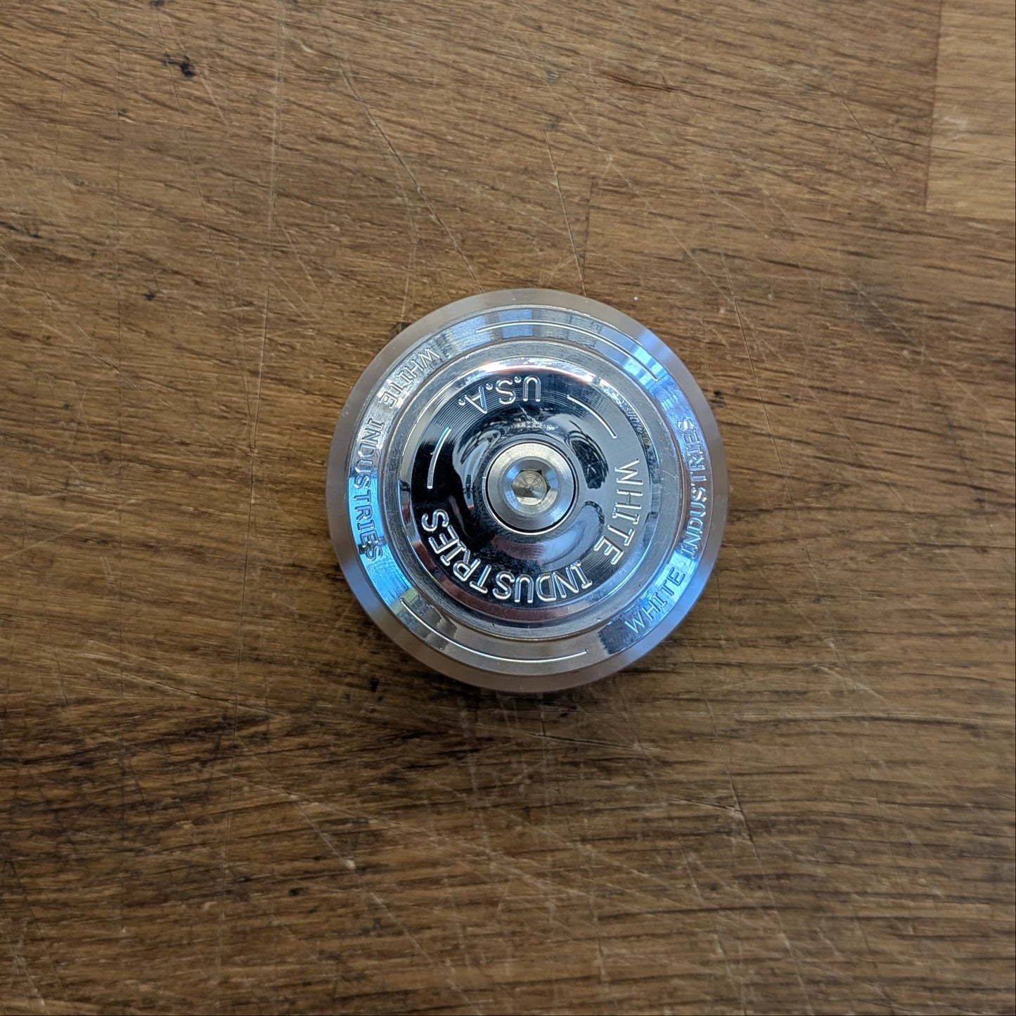 Clear plastic object with text on a wooden surface