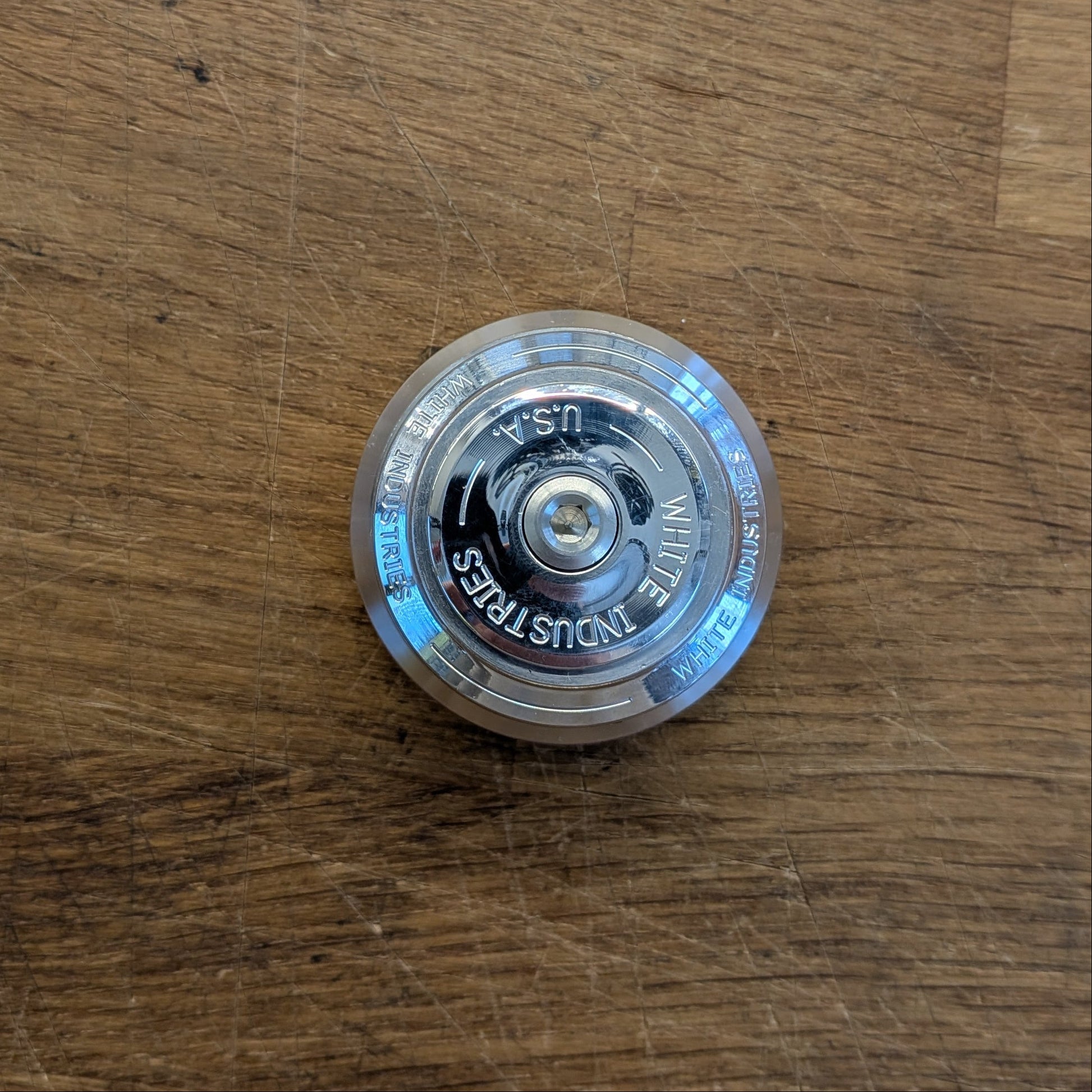 Clear plastic object with text on a wooden surface