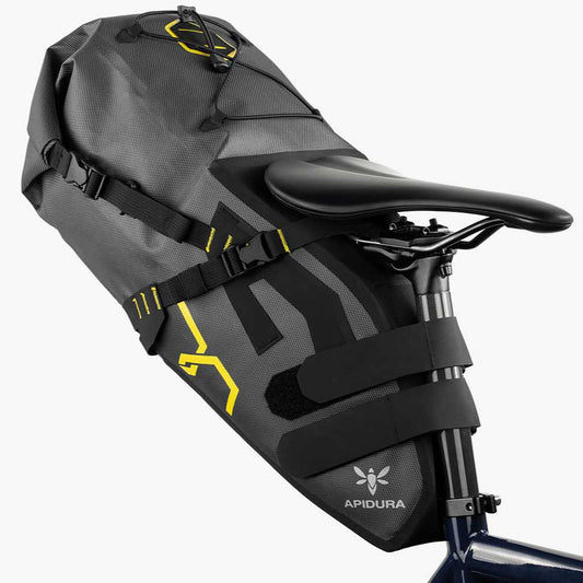 Apidura bikepacking bag attached to a bicycle seat on a white background
