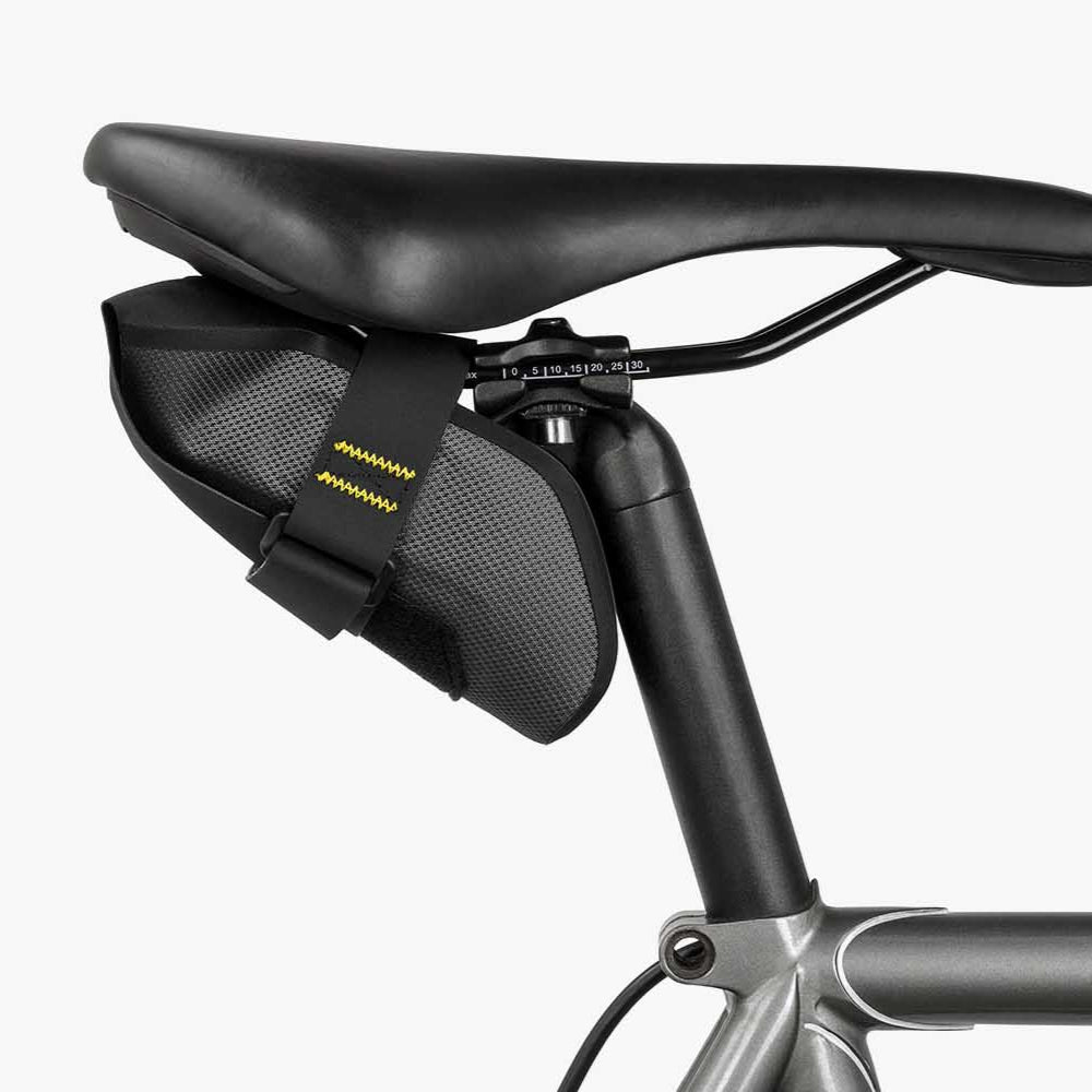 Bicycle saddle bag attached to a bike seat on a white background